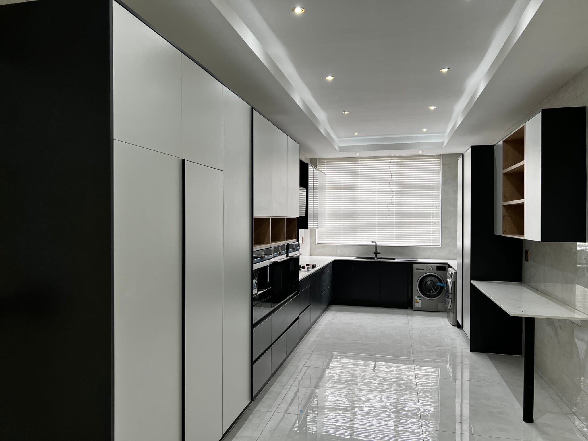 Galley kitchen, black and white cabinetry