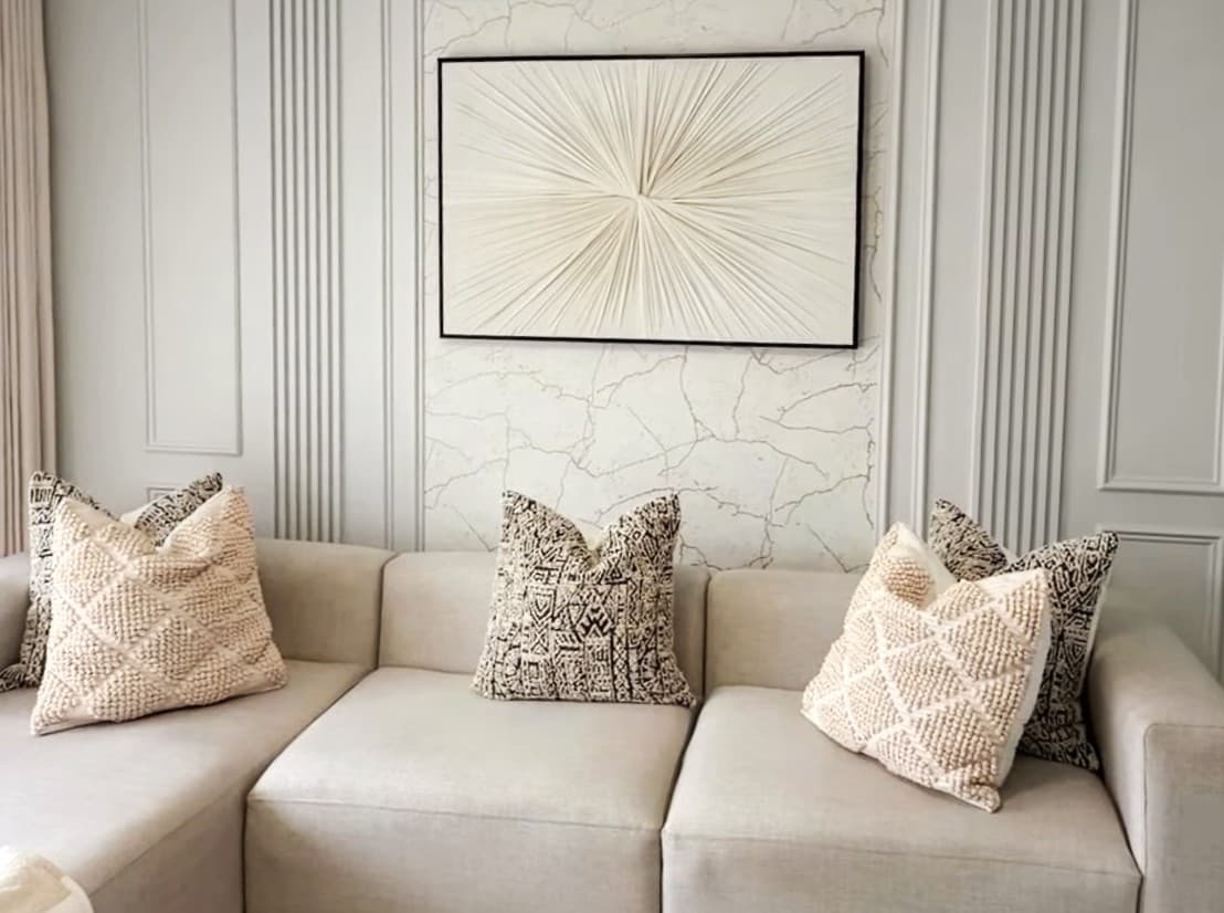 Marble-inset panel wall with fluted trim, living room