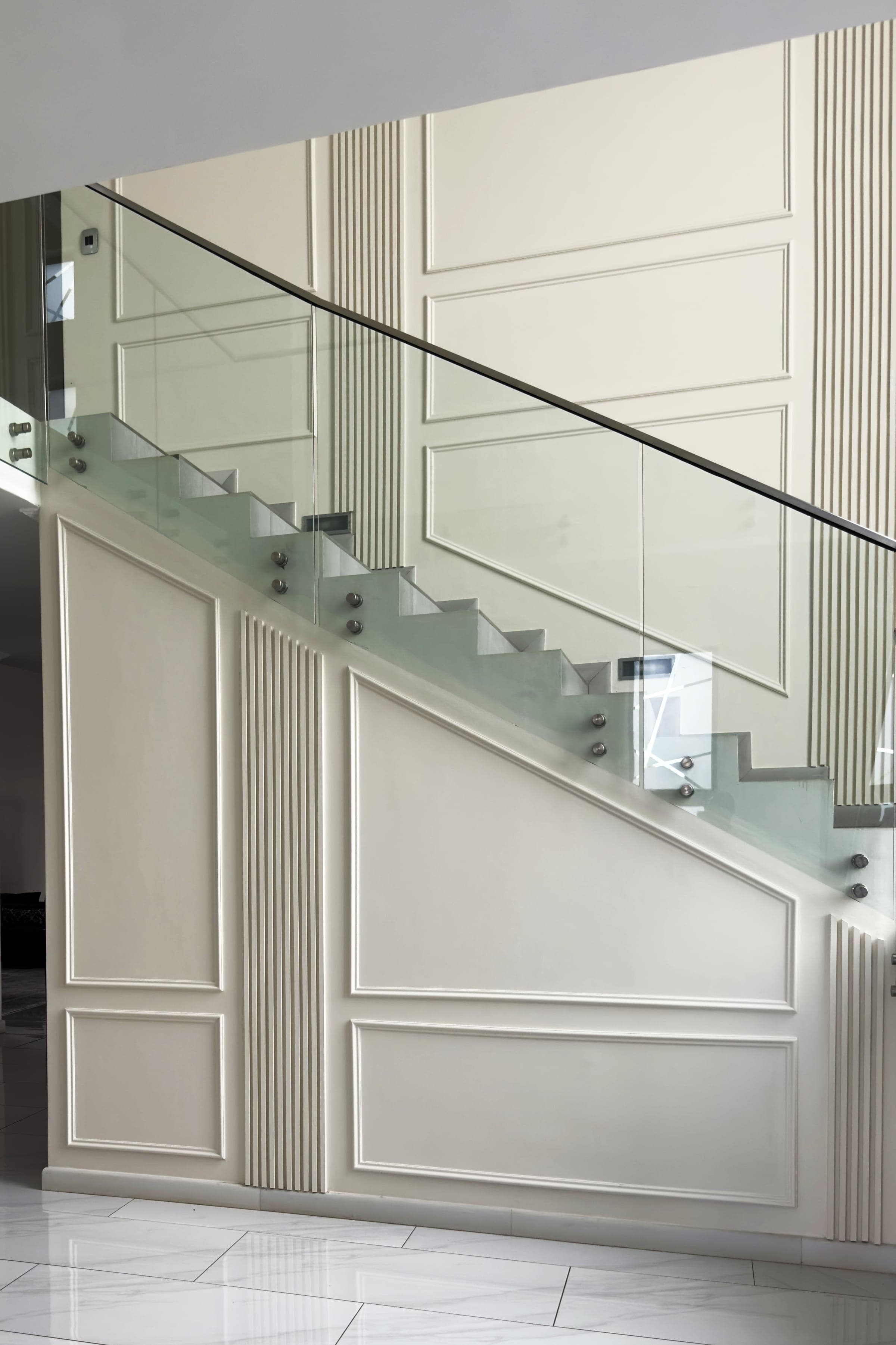 Staircase wall panelling, fluted pilasters and glass rail