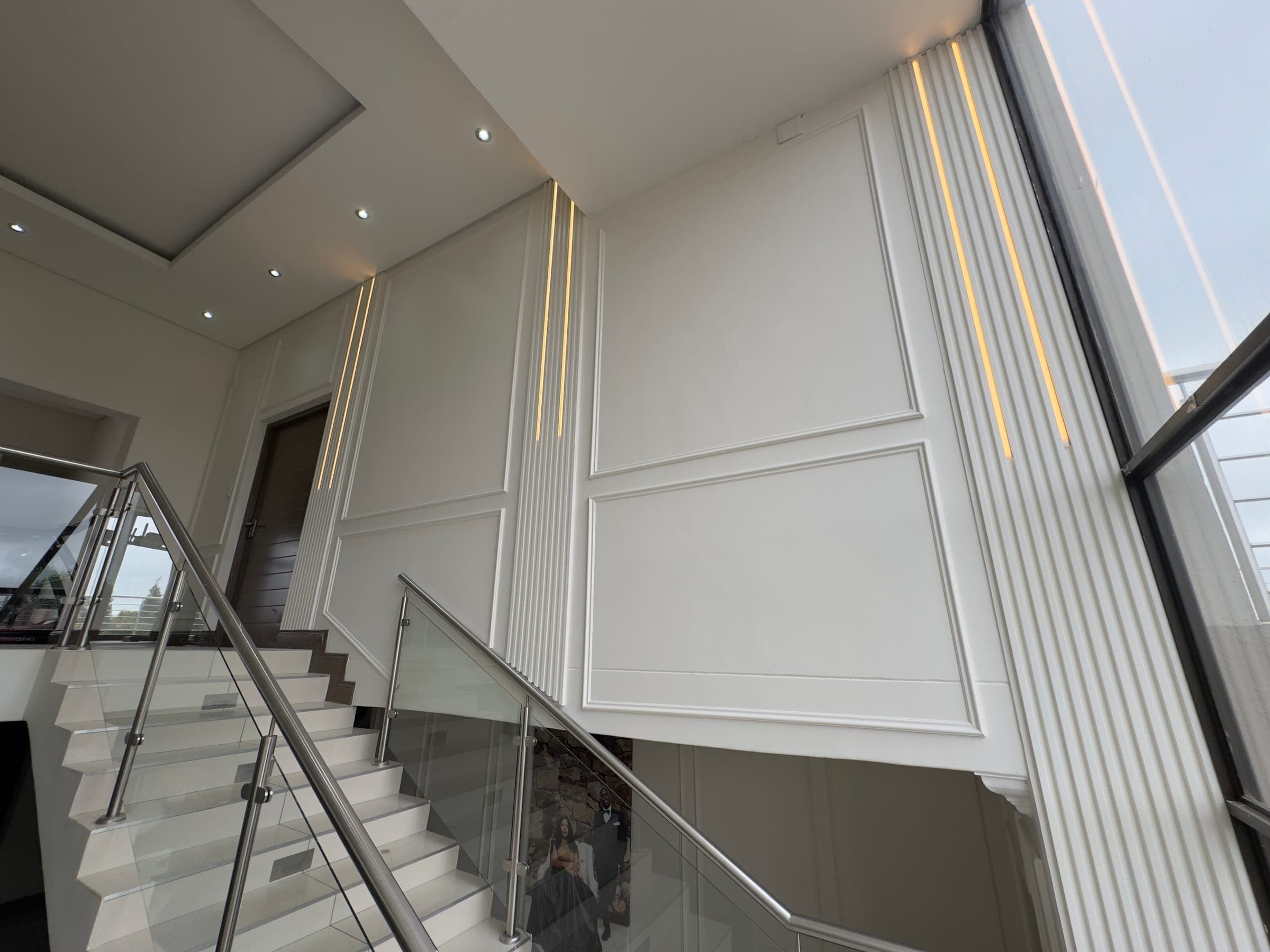 White panel moulding staircase wall, LED strip lighting