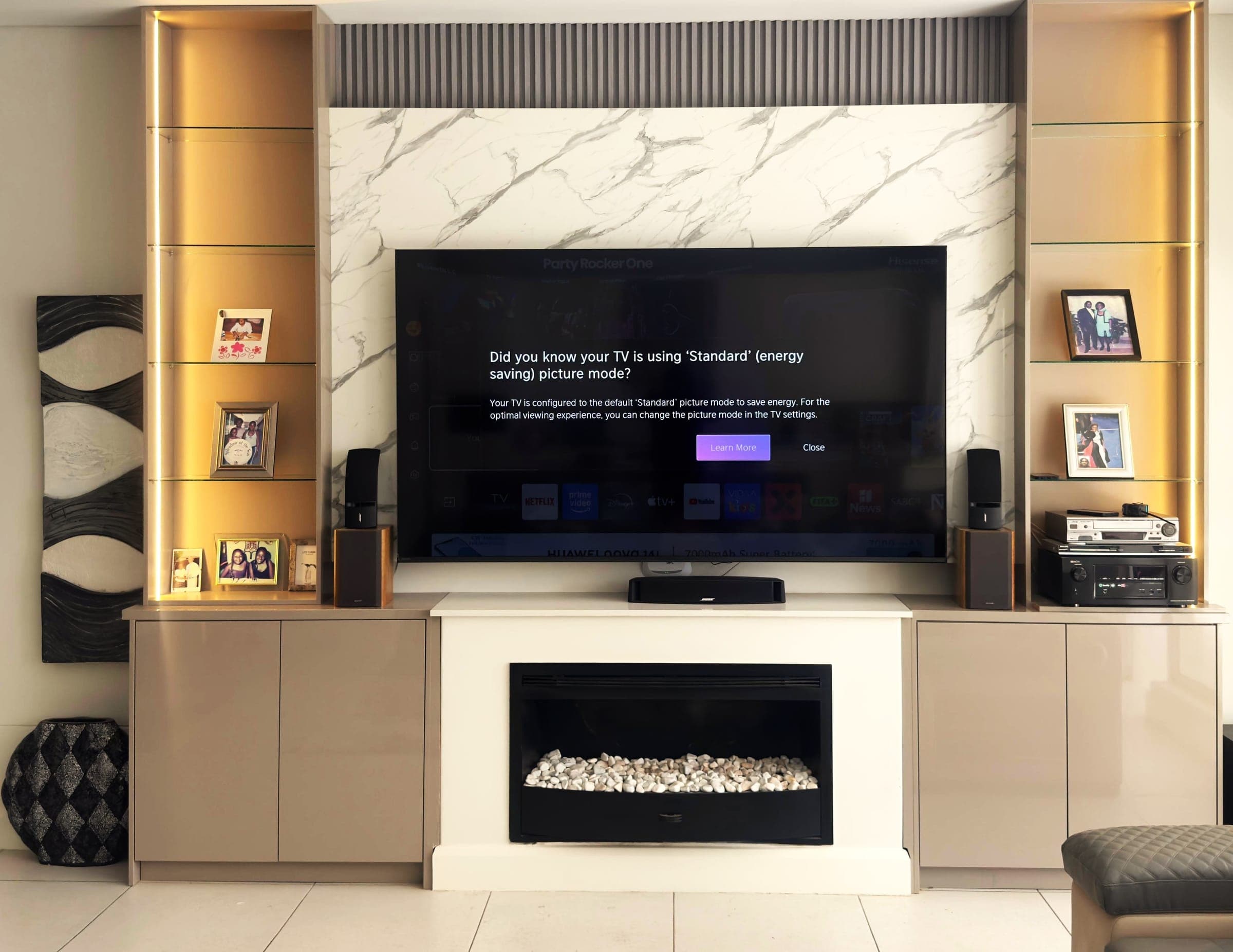 Marble TV wall with backlit glass display shelving